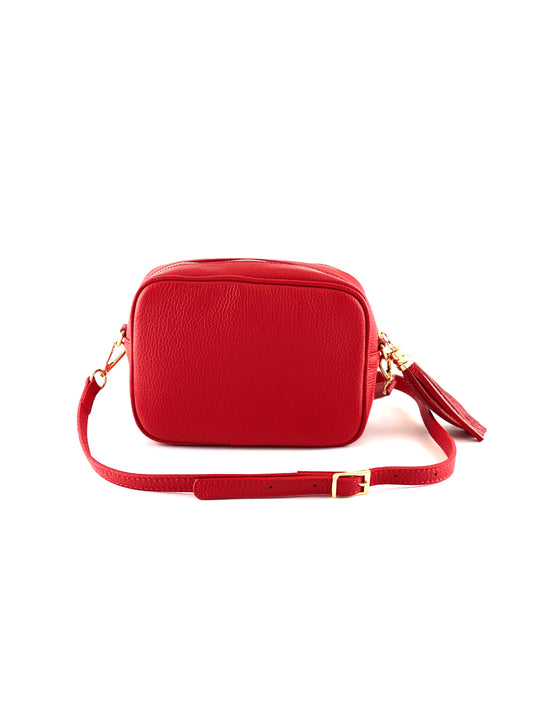 An image of a small red leather messenger bag with a leather tassel on the zip which opens across the top of the bag.