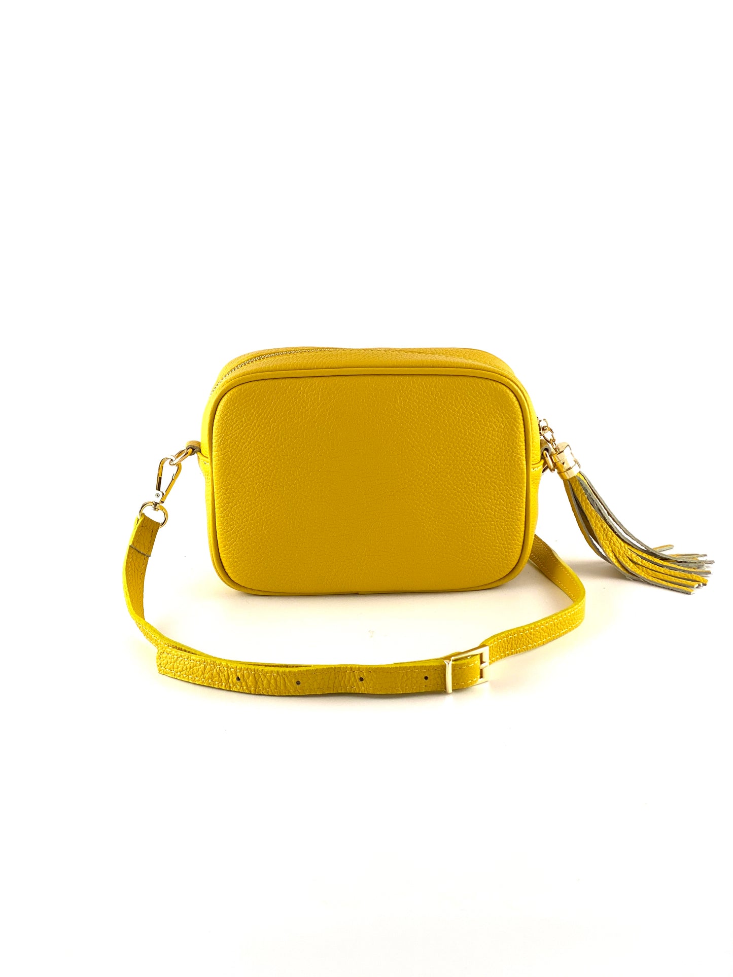 An image of a small yellow leather messenger bag with a leather tassel on the zip which opens across the top of the bag.