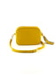 An image of a small yellow leather messenger bag with a leather tassel on the zip which opens across the top of the bag.